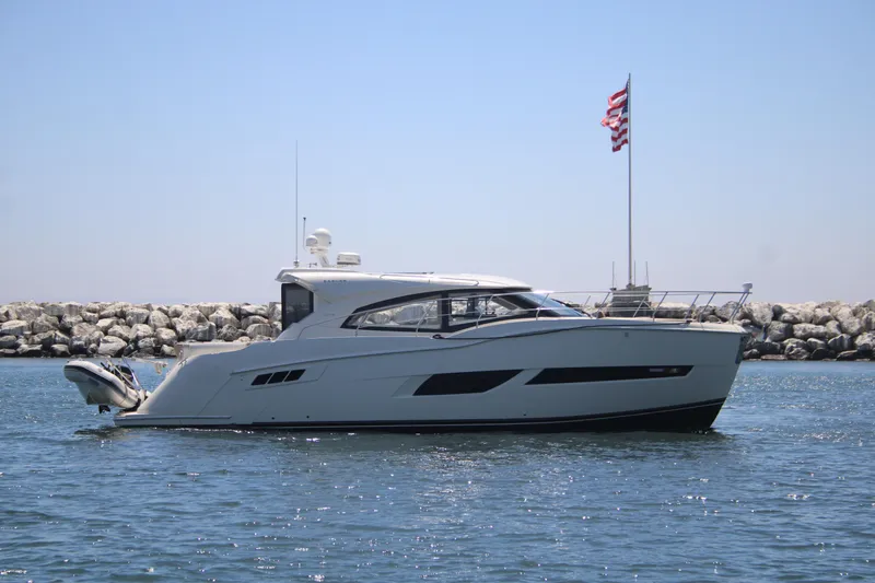 Skywalker Yacht Photos Pics Luxurious 2018 Carver C43 Coupe yacht cruising near rocky shoreline.