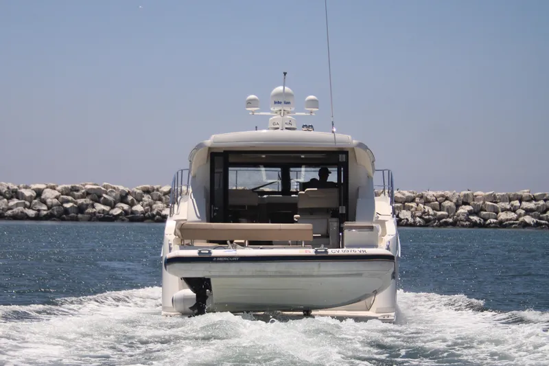 Skywalker Yacht Photos Pics Rear view of a 2018 Carver C43 Coupe yacht cruising on the water.