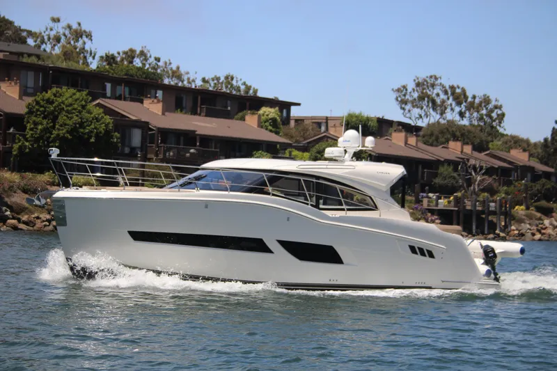 Skywalker Yacht Photos Pics 2018 Carver C43 Coupe yacht cruising near waterfront homes.