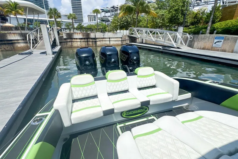  Yacht Photos Pics Luxury 2018 Statement 380 Open boat with triple engines docked in a marina.