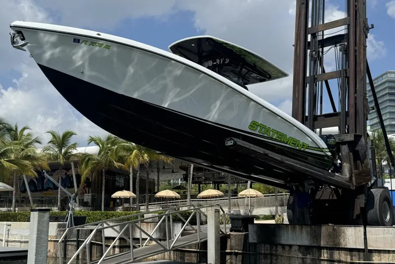  Yacht Photos Pics 2018 Statement 380 Open boat lifted at marina with palm trees in background.