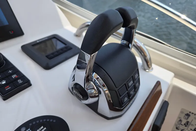 Eagle Wing Yacht Photos Pics Throttle controls on a 2017 MJM 40z Downeast boat dashboard, featuring modern navigation equipment.