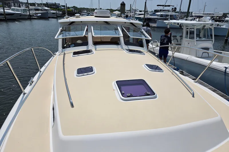 Eagle Wing Yacht Photos Pics 2017 MJM 40z Downeast yacht docked at marina, showcasing spacious deck and sleek design.