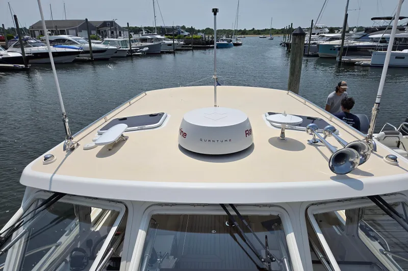 Eagle Wing Yacht Photos Pics 2017 MJM 40z Downeast boat docked, featuring radar and horn on the roof.