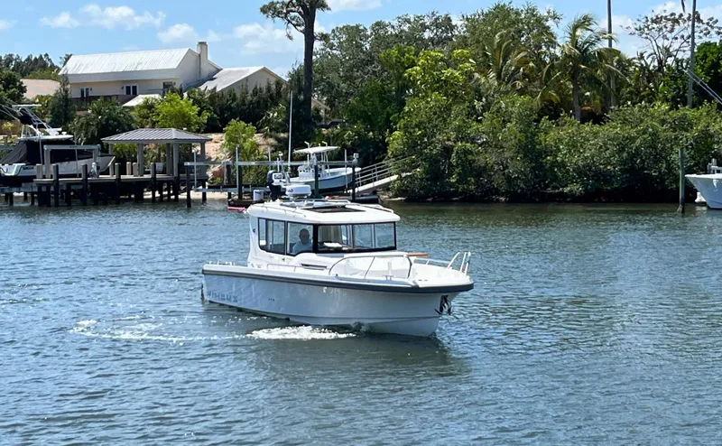 In-stock 2024 Nimbus C9 #158 Yacht Photos Pics 2024 Nimbus Commuter 9 #158 boat cruising on a sunny day near a dock.