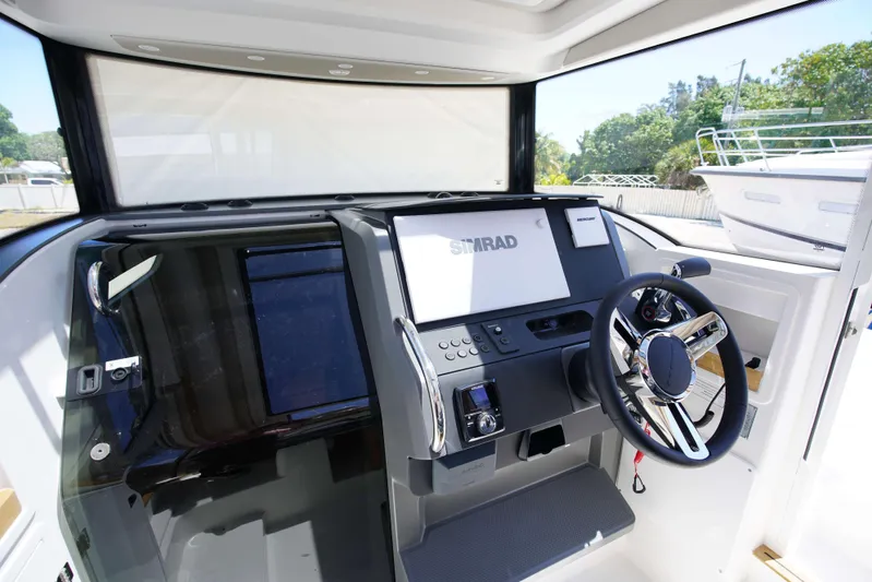 In-stock 2024 Nimbus C9 #158 Yacht Photos Pics 2024 Nimbus Commuter 9 #158 boat cockpit with modern steering wheel and navigation system.