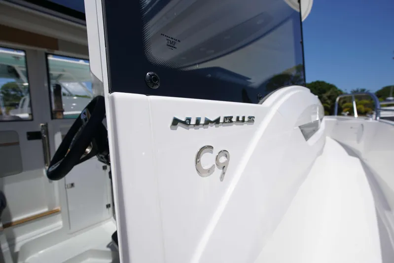 In-stock 2024 Nimbus C9 #158 Yacht Photos Pics 2024 Nimbus Commuter 9 #158 boat, close-up of logo and cockpit area.