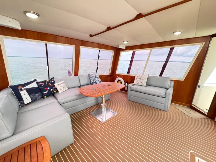 Sunshine State Yacht Photos Pics Interior of 1987 Viking 48 Motoryacht with gray sofas and wooden table.