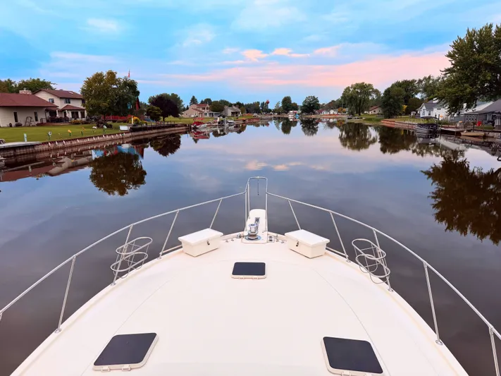 Sunshine State Yacht Photos Pics Viking 48 Motoryacht 1987 on calm river at sunset.