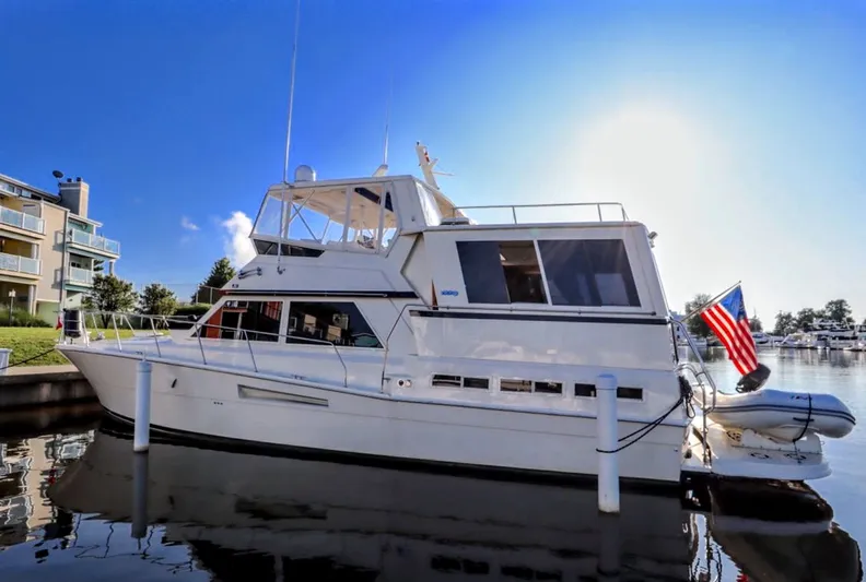 Sunshine State Yacht Photos Pics 1987 Viking 48 Motoryacht docked with American flag.