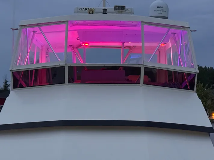 Sunshine State Yacht Photos Pics 1987 Viking 48 Motoryacht with pink lighting, front view.