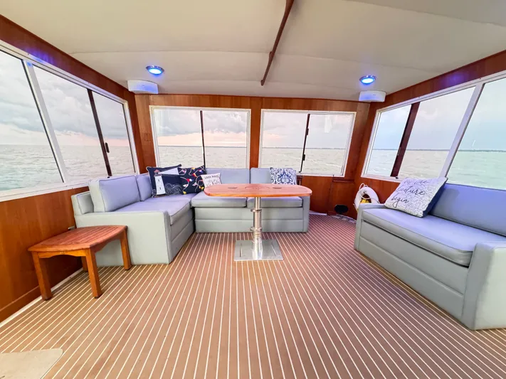 Sunshine State Yacht Photos Pics Interior of 1987 Viking 48 Motoryacht with gray sofas and wooden table.