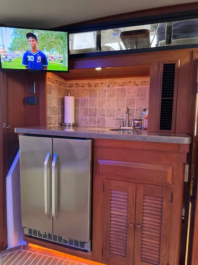 Sunshine State Yacht Photos Pics Interior of 1987 Viking 48 Motoryacht with kitchenette and TV.