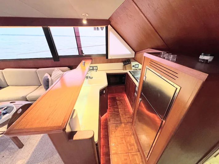 Sunshine State Yacht Photos Pics Interior of 1987 Viking 48 Motoryacht with kitchen and sofa.