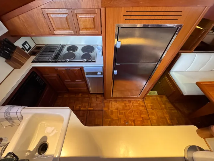 Sunshine State Yacht Photos Pics 1987 Viking 48 Motoryacht kitchen with wood cabinets and stainless steel appliances.