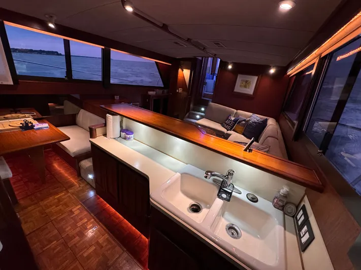 Sunshine State Yacht Photos Pics Interior of 1987 Viking 48 Motoryacht with kitchen and seating area.