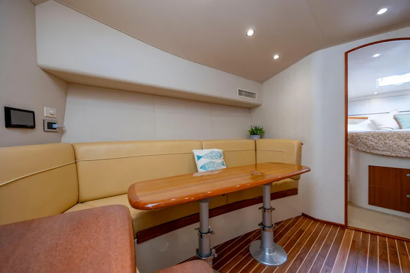 Life Is Good Yacht Photos Pics Interior of 2013 Viking 42 yacht with beige seating and wooden table.