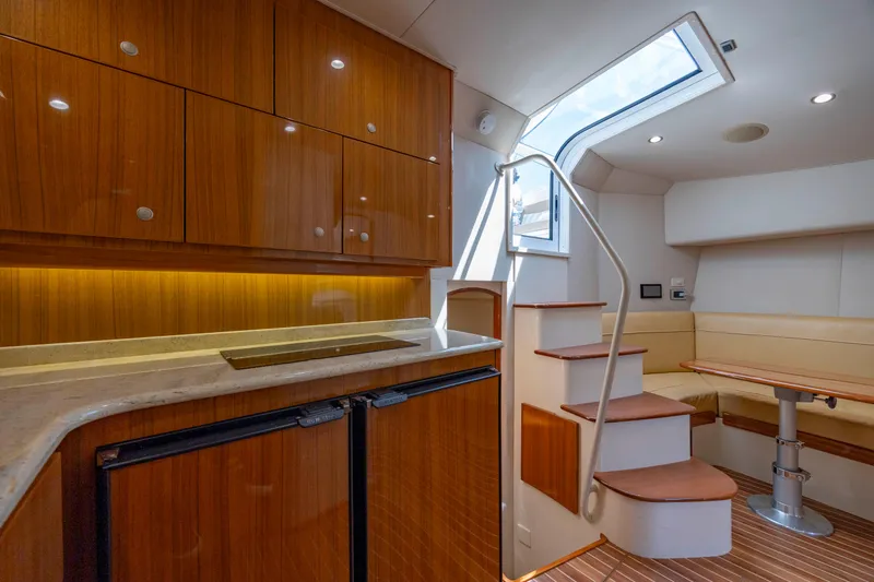 Life Is Good Yacht Photos Pics Luxurious interior of 2013 Viking 42 yacht with wooden cabinetry and cozy seating area.