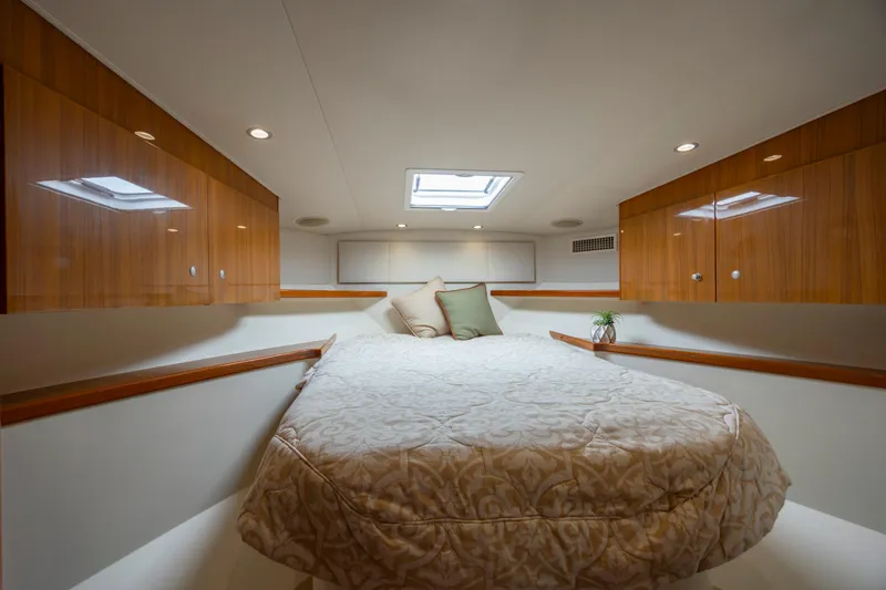 Life Is Good Yacht Photos Pics Luxurious cabin interior of 2013 Viking 42 yacht with cozy bed and wooden accents.