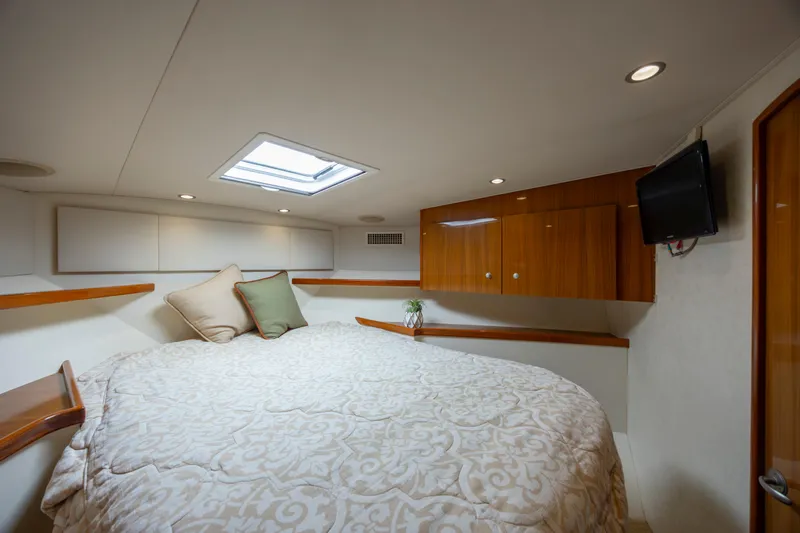 Life Is Good Yacht Photos Pics Luxurious cabin interior of 2013 Viking 42 yacht with cozy bedding and wooden cabinetry.