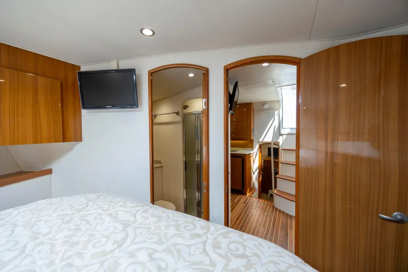 Life Is Good Yacht Photos Pics Interior of 2013 Viking 42 yacht with wood finishes, TV, and stairs.