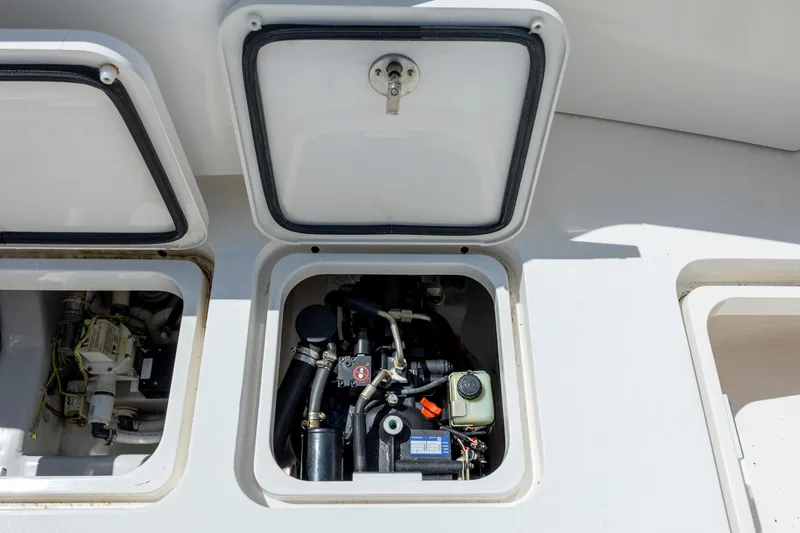 Life Is Good Yacht Photos Pics Engine compartment of a 2013 Viking 42 boat, showcasing mechanical components and open hatches.