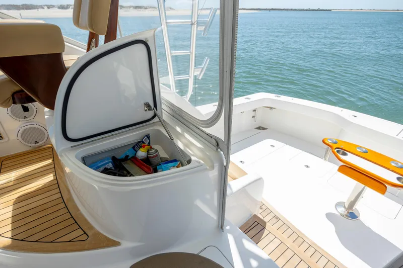 Life Is Good Yacht Photos Pics 2013 Viking 42 yacht deck with open storage compartment, overlooking serene water.
