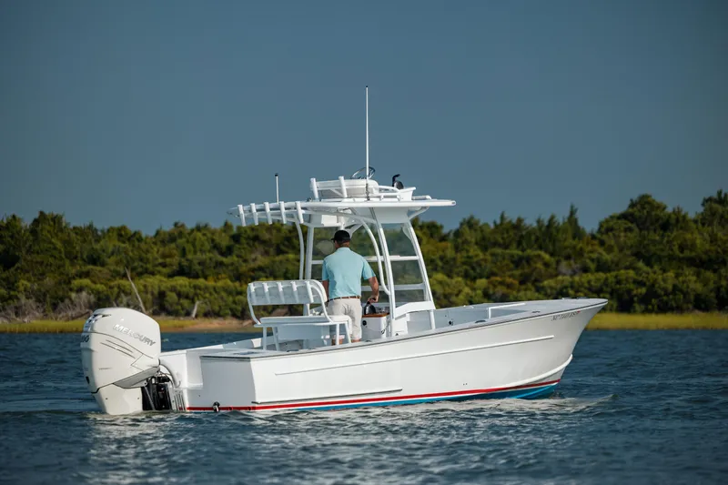  Yacht Photos Pics 2019 Gamefisherman 26 Cuddy Cabin boat cruising on a calm lake.