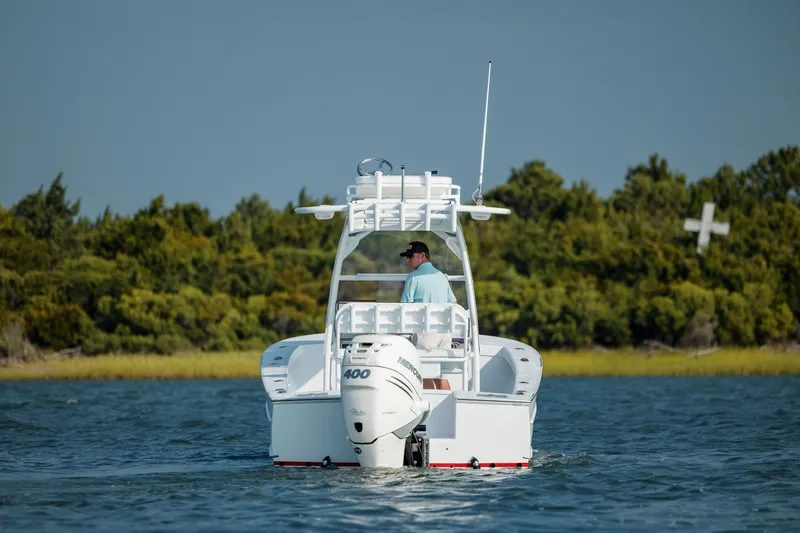 Yacht Photos Pics 2019 Gamefisherman 26 Cuddy Cabin boat cruising on a lake.