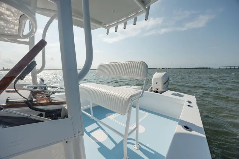  Yacht Photos Pics 2019 Gamefisherman 26 Cuddy Cabin boat on water, featuring white seating and steering console.