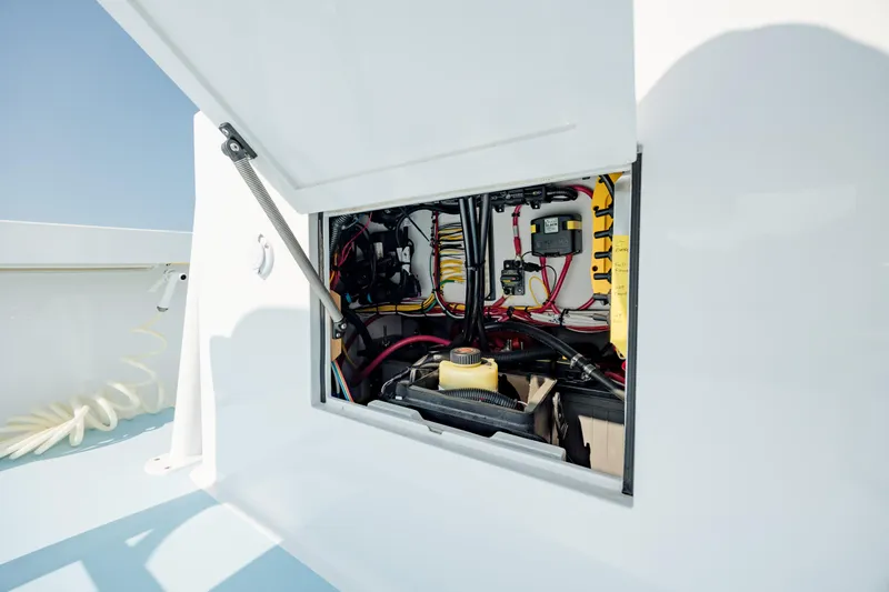  Yacht Photos Pics Open hatch of a 2019 Gamefisherman 26 Cuddy Cabin showing internal wiring and components.