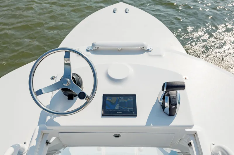  Yacht Photos Pics 2019 Gamefisherman 26 Cuddy Cabin helm with steering wheel, navigation screen, and throttle controls.