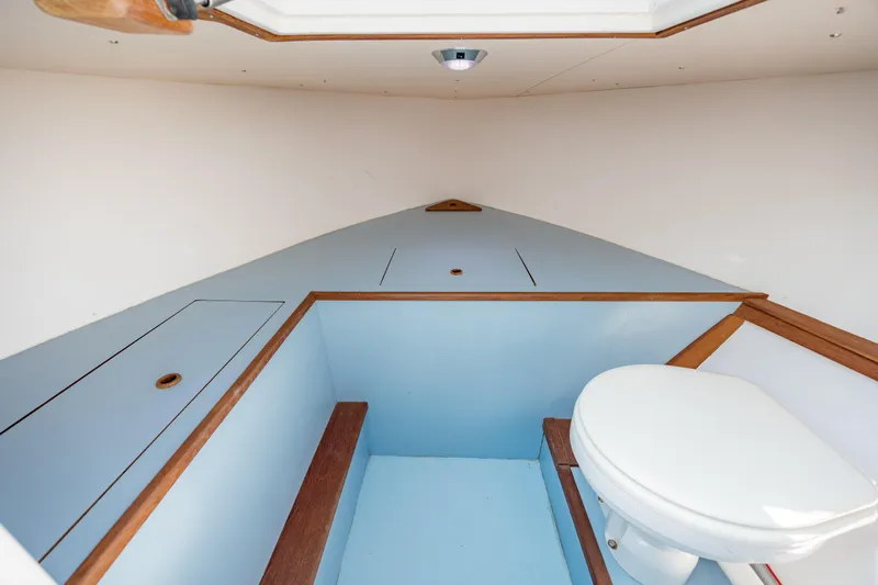  Yacht Photos Pics 2019 Gamefisherman 26 Cuddy Cabin interior with toilet and storage compartments.