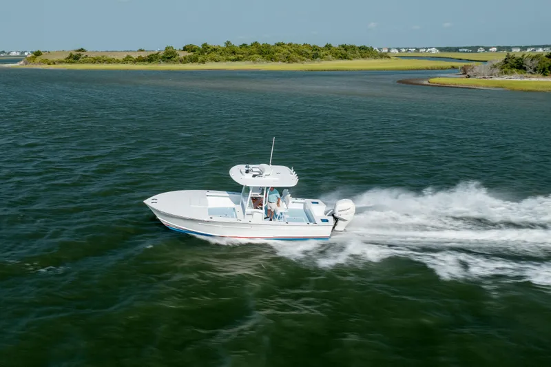  Yacht Photos Pics 2019 Gamefisherman 26 Cuddy Cabin boat cruising on open water.