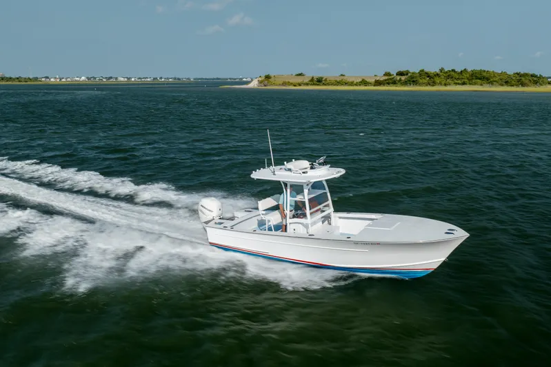  Yacht Photos Pics 2019 Gamefisherman 26 Cuddy Cabin boat cruising on open water.