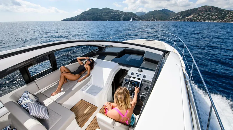  Yacht Photos Pics 2026 Fairline Targa 45 Open yacht cruising with passengers, scenic coastal backdrop.