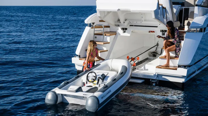  Yacht Photos Pics 2026 Fairline Targa 45 Open yacht with tender boat on ocean.