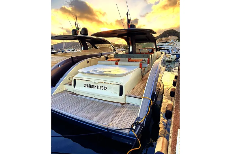  Yacht Photos Pics 2024 Invictus TT 420 yacht docked at sunset, showcasing sleek design and luxury features.