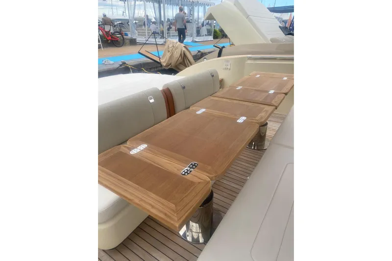  Yacht Photos Pics 2024 Invictus TT 420 yacht interior with elegant wooden table and seating area.