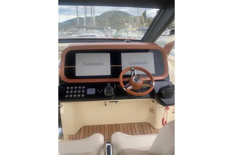 Yacht Photos Pics 2024 Invictus TT 420 helm with Garmin displays and wooden steering wheel.