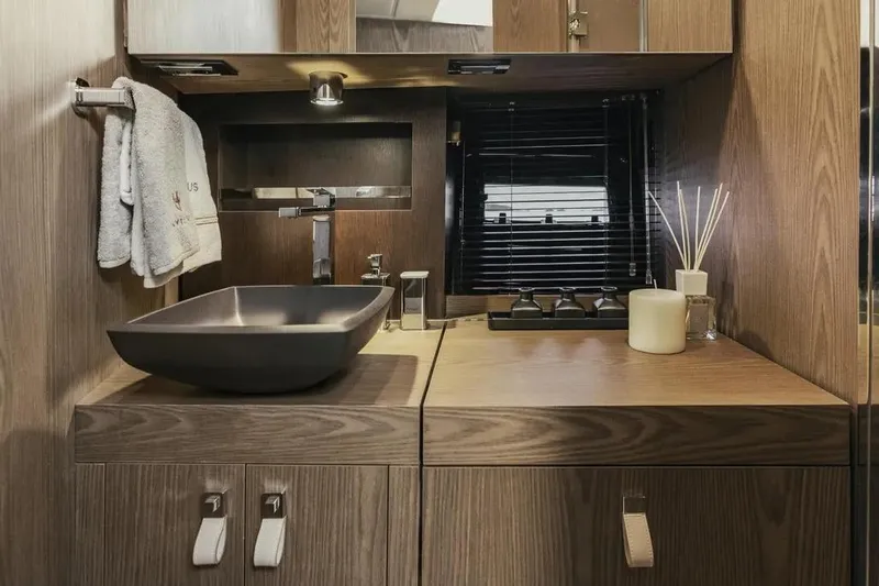  Yacht Photos Pics Luxurious bathroom interior of 2024 Invictus TT 420 yacht with modern sink and wooden cabinetry.