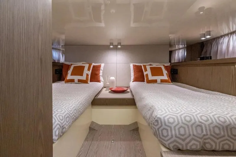 Yacht Photos Pics Luxurious 2024 Invictus TT 420 yacht cabin with twin beds and stylish decor.