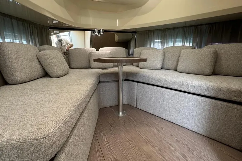  Yacht Photos Pics Luxurious interior of 2024 Invictus TT 420 with plush seating and wooden table.