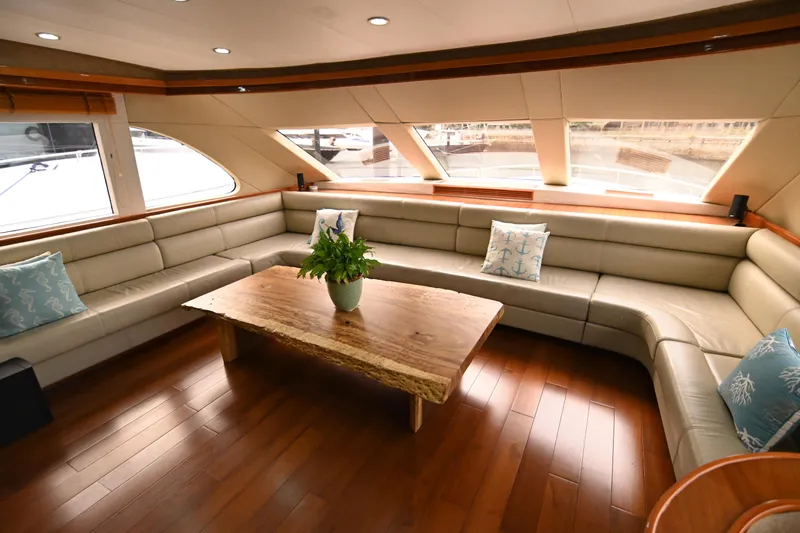  Yacht Photos Pics Luxurious yacht interior with beige seating, wooden table, and decorative pillows, Accelera 82, 2014.