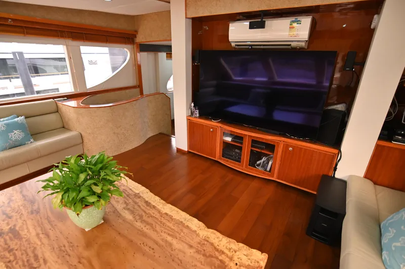  Yacht Photos Pics Luxurious yacht interior with large TV, wooden flooring, and elegant seating, Accelera 82, 2014 model.