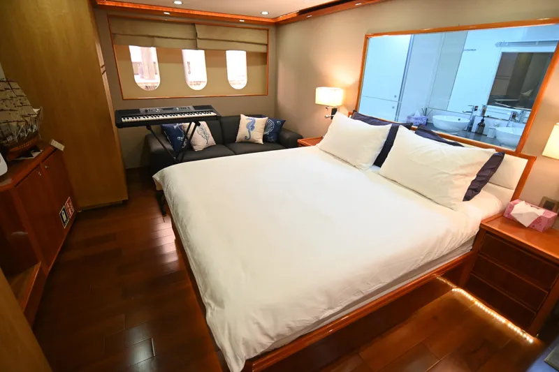  Yacht Photos Pics Luxurious yacht bedroom with a large bed, keyboard, and elegant wooden flooring, Accelera 82, 2014.