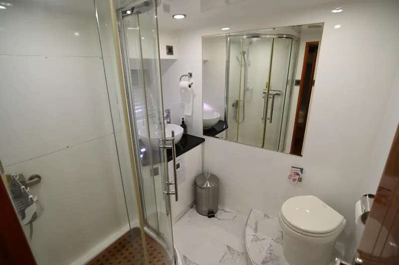  Yacht Photos Pics Modern bathroom with glass shower, white fixtures, and marble flooring in Accelera 82 yacht, 2014.