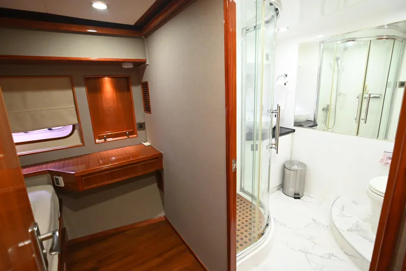  Yacht Photos Pics Luxurious interior of 2014 Accelera 82 yacht featuring a modern bathroom and wooden desk area.