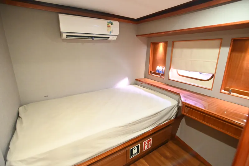  Yacht Photos Pics Compact cabin interior with bed, wooden accents, and air conditioning in a 2014 Accelera 82 model.