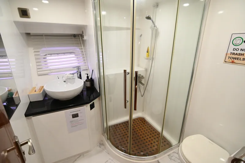  Yacht Photos Pics Luxurious bathroom in 2014 Accelera 82 yacht with shower, sink, and toilet.